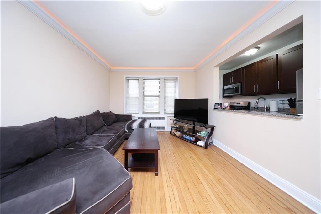 9281 Shore Road, Unit 220 Brooklyn, NY 11209 - Photo 12 of 17 a living room with furniture and a flat screen tv