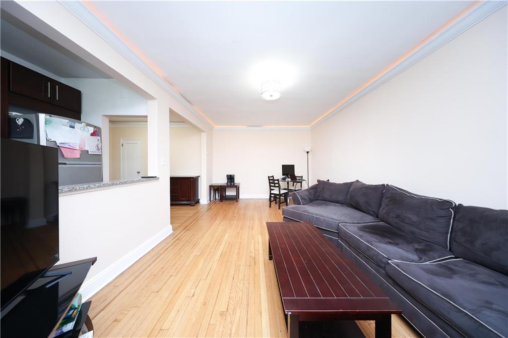9281 Shore Road, Unit 220 Brooklyn, NY 11209 - Photo 13 of 17 a living room with furniture and a flat screen tv