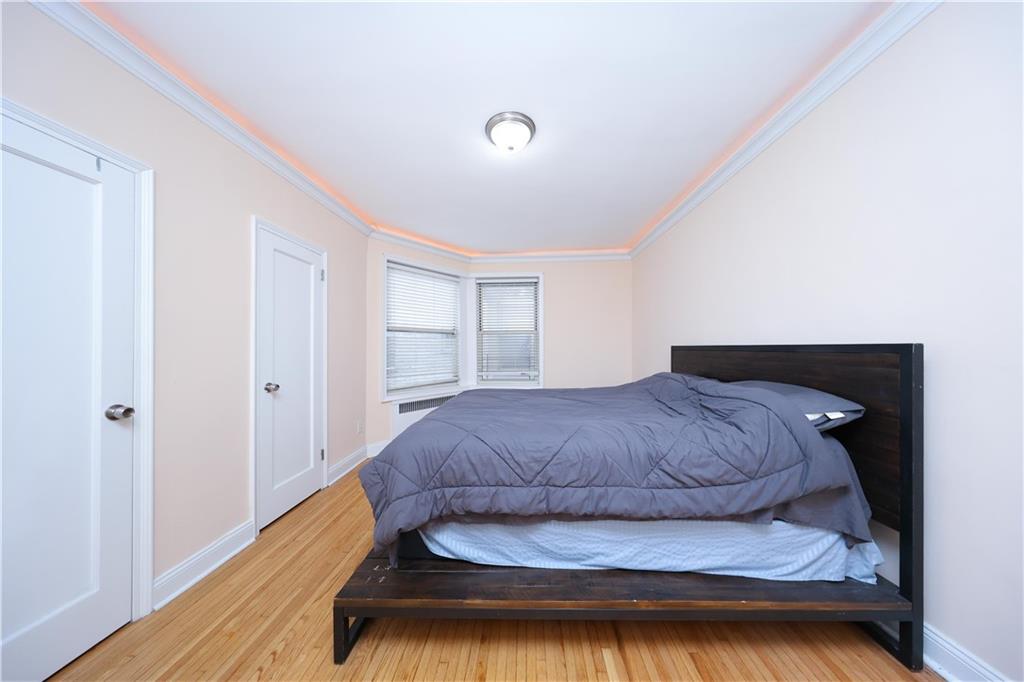 9281 Shore Road, Unit 220 Brooklyn, NY 11209 - Photo 14 of 17 a bedroom with a bed and window