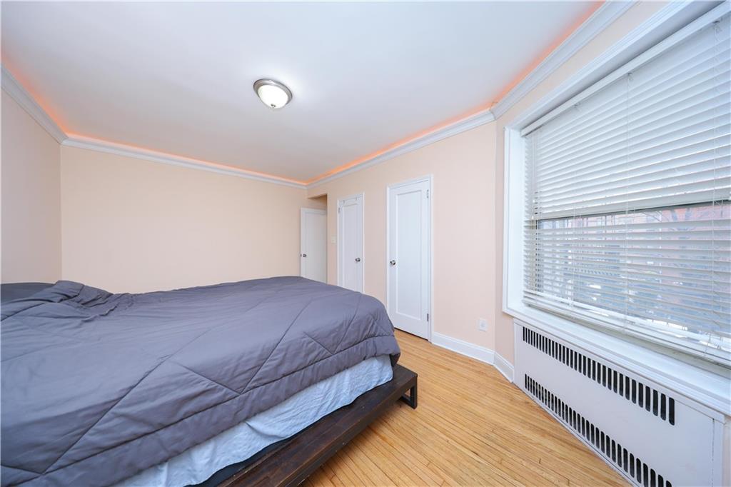 9281 Shore Road, Unit 220 Brooklyn, NY 11209 - Photo 16 of 17 a bedroom with a bed and a large window