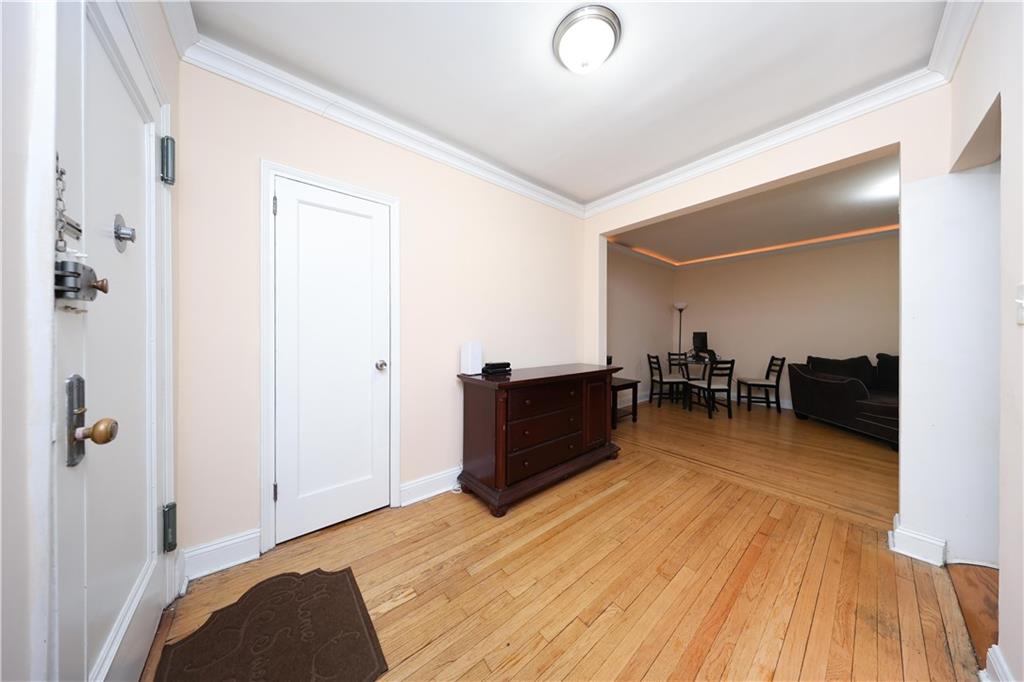 9281 Shore Road, Unit 220 Brooklyn, NY 11209 - Photo 9 of 17 a living room with furniture and a wooden floor