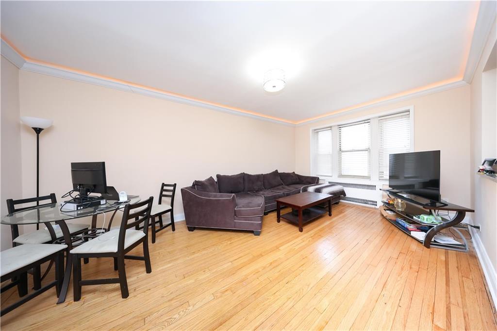 9281 Shore Road, Unit 220 Brooklyn, NY 11209 - Photo 10 of 17 a living room with furniture and a flat screen tv