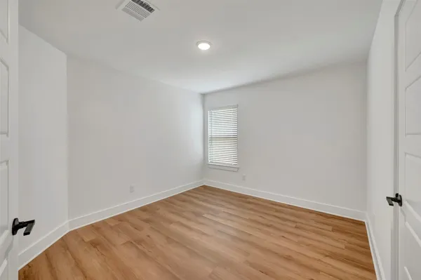 a view of an empty room and wooden floor