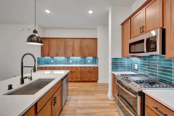 a view of a room with wooden floor and a window