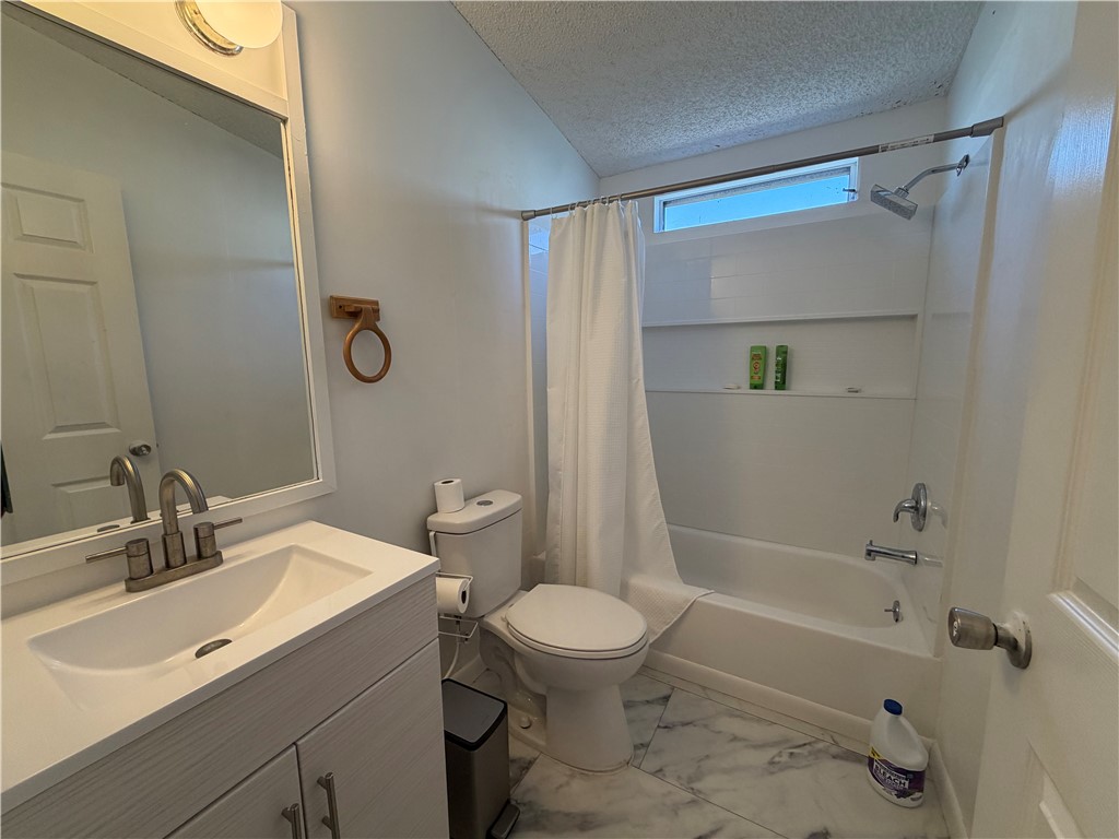 1910 Rio Grande Road Bullhead City, AZ 86442 - Photo 23 of 29 Bathroom featuring a light-toned vanity with brushed nickel hardware, a rectangular undermount sink, and a framed mirror