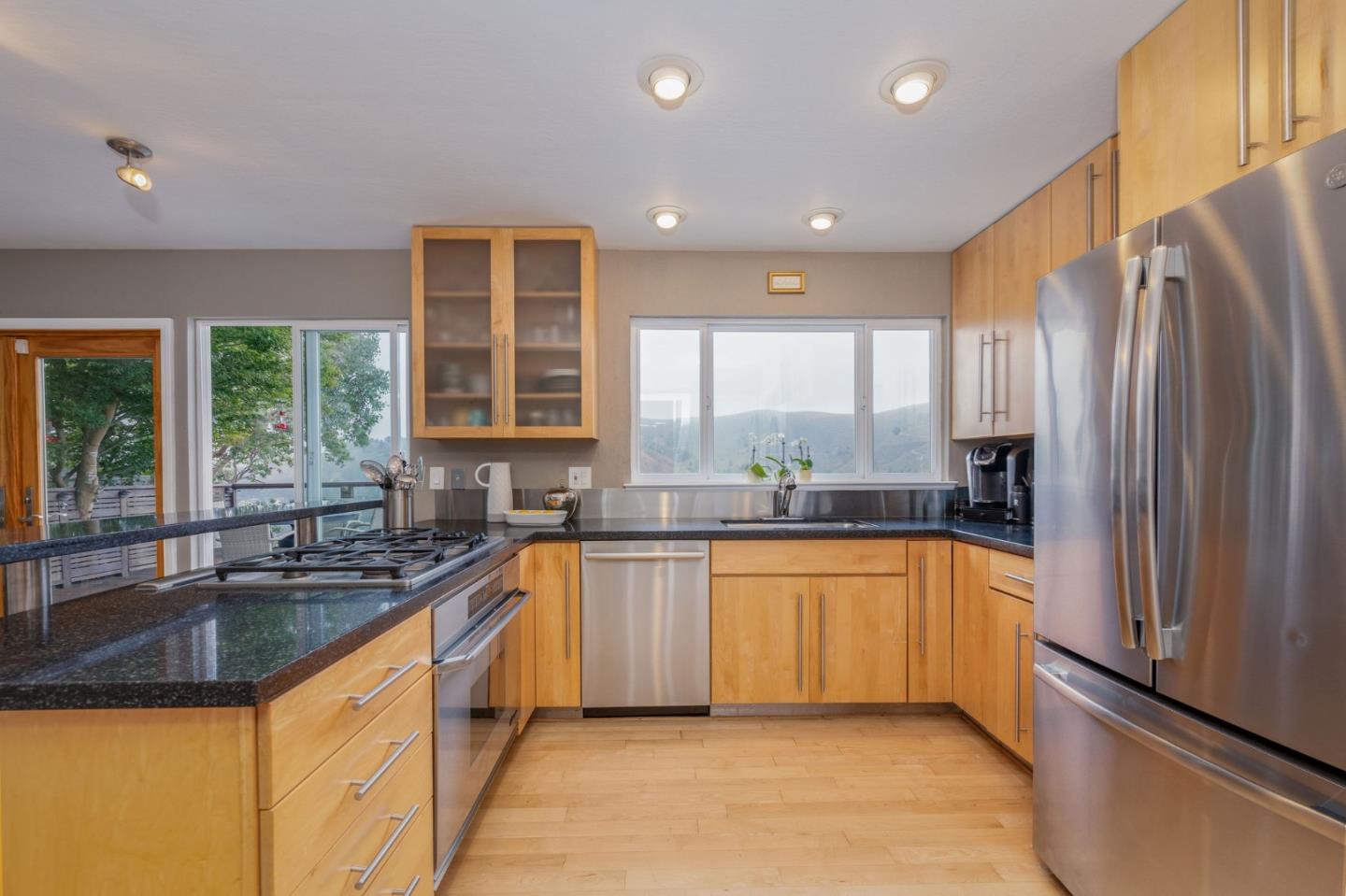 63 Kathleen Court Pacifica, CA 94044 - Photo 12 of 41 a kitchen with stainless steel appliances granite countertop a sink and a refrigerator