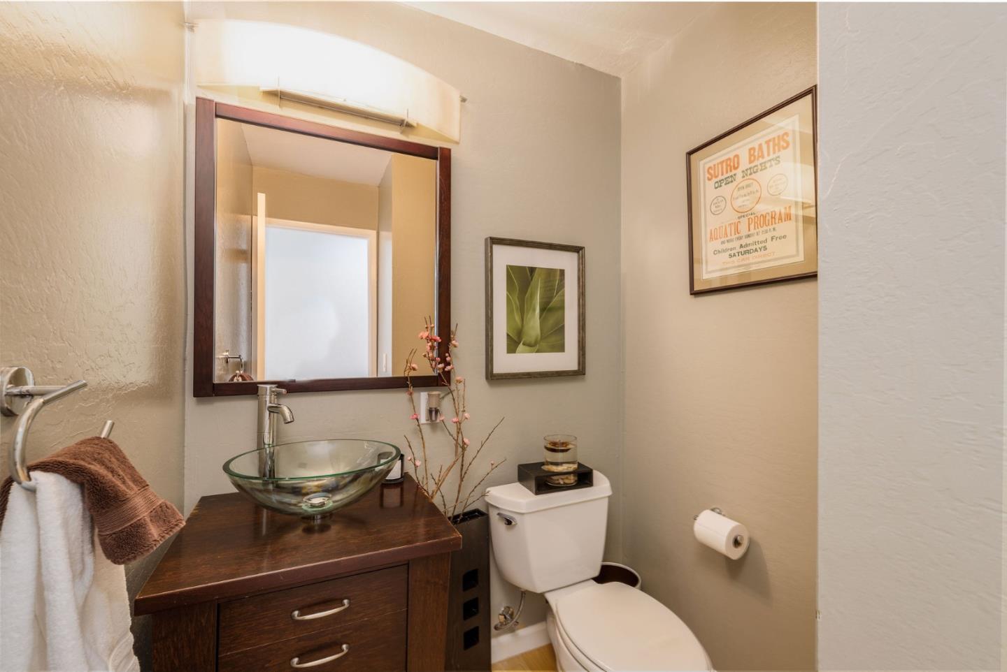 63 Kathleen Court Pacifica, CA 94044 - Photo 14 of 41 a bathroom with a toilet a sink and mirror