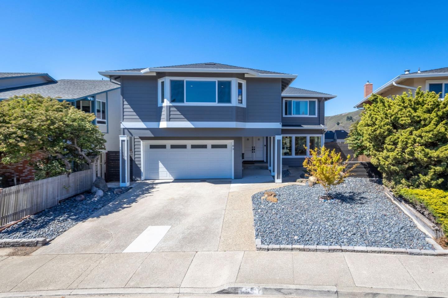 63 Kathleen Court Pacifica, CA 94044 - Photo 2 of 41 a front view of a house with a yard and garage