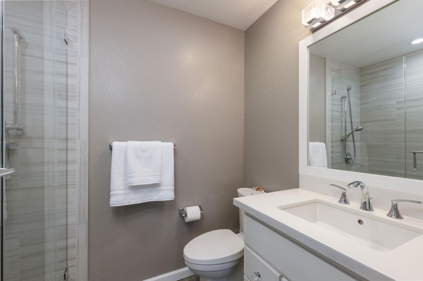 63 Kathleen Court Pacifica, CA 94044 - Photo 32 of 41 a bathroom with a sink toilet and a mirror