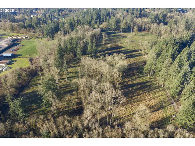 a view of a yard with wooden fence