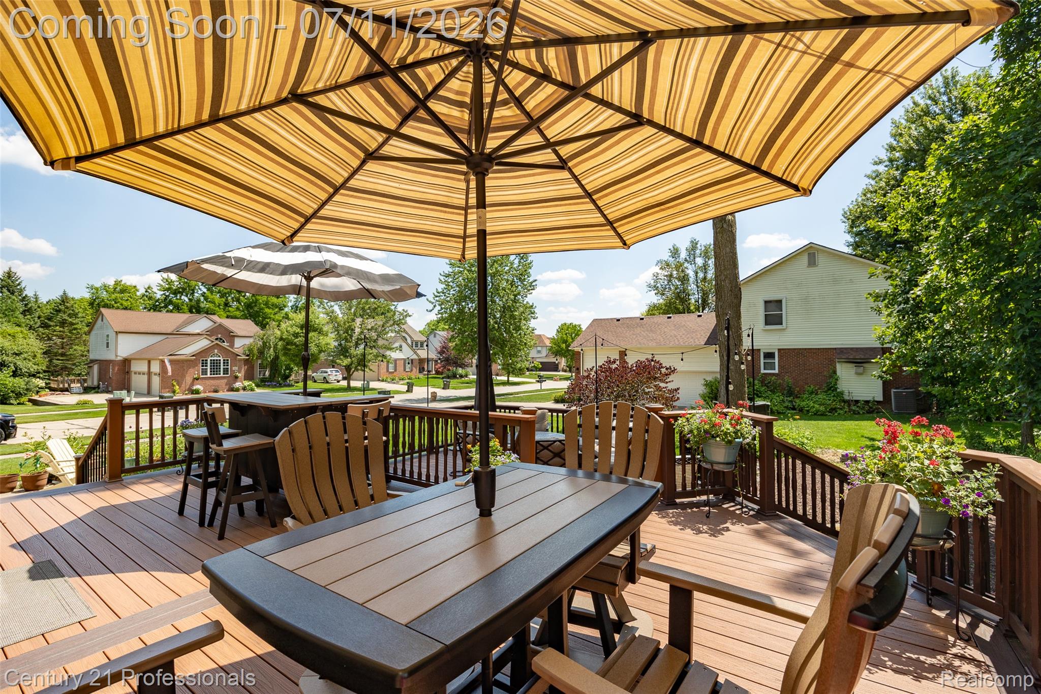 689 Woodfield Way Rochester, MI 48307 - Photo 30 of 61 Spacious outdoor deck featuring composite decking, dark wood railings, and multiple distinct gathering areas