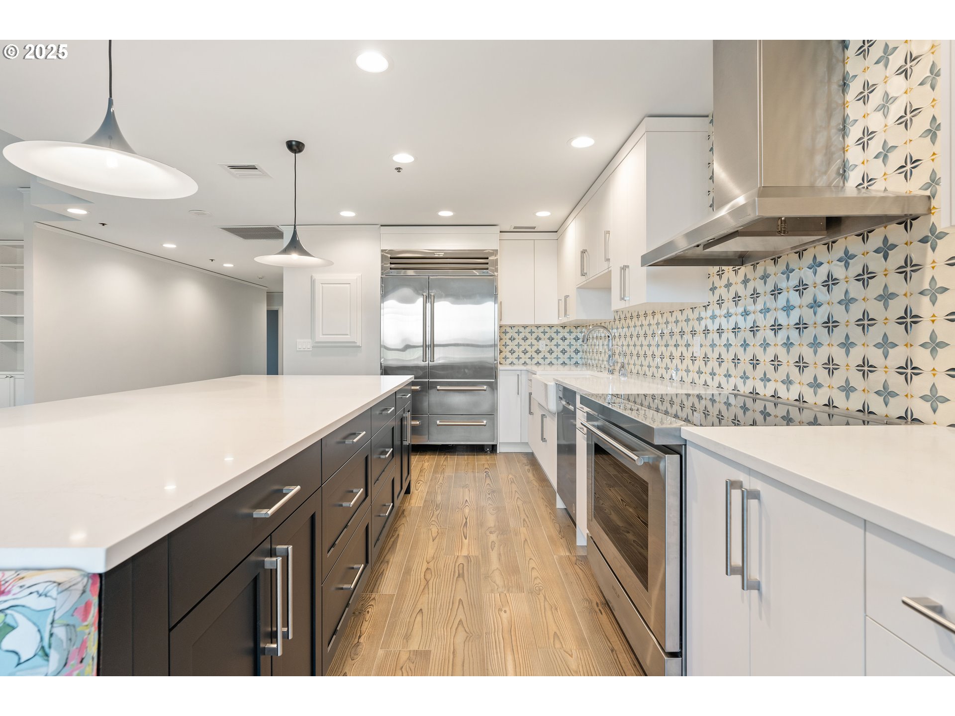 1414 Southwest 3rd Avenue, Unit 2902 Portland, OR 97201 - Photo 18 of 45 a kitchen with stainless steel appliances granite countertop a sink a stove and a wooden floors