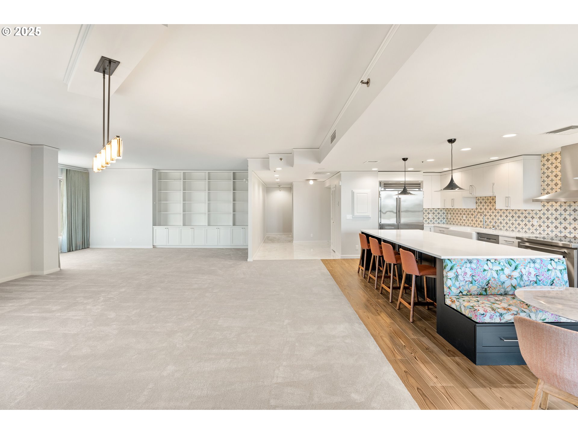 1414 Southwest 3rd Avenue, Unit 2902 Portland, OR 97201 - Photo 6 of 45 a large white kitchen with kitchen island a sink stainless steel appliances and cabinets