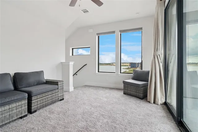 a living room with furniture and a floor to ceiling window