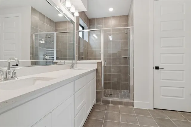 a bathroom with a shower sink and mirror