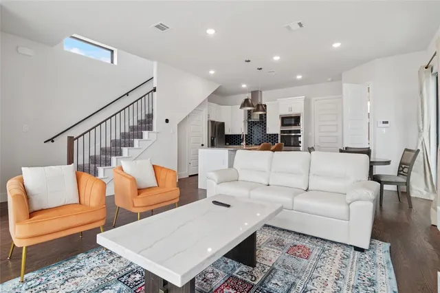 a living room with furniture kitchen view and a table