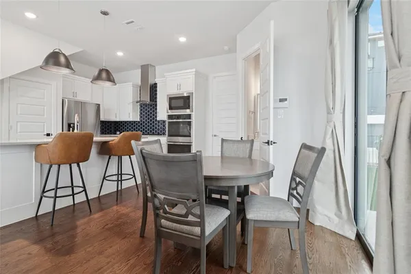 a view of a dining room with furniture and wooden floor