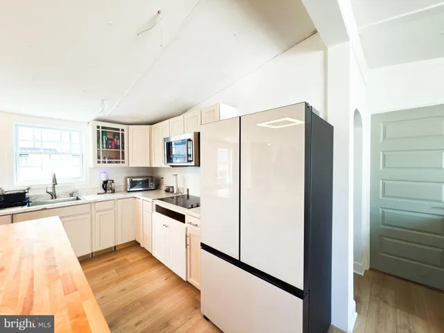 a kitchen with stainless steel appliances a refrigerator sink and cabinets