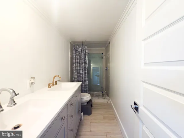 a bathroom with a sink a toilet a mirror and vanity