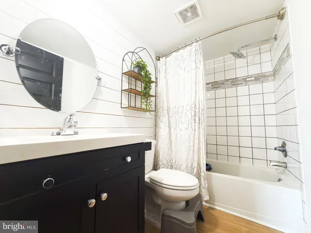 a bathroom with a sink a toilet and bathtub