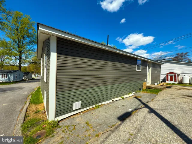 a view of a backyard with a tree