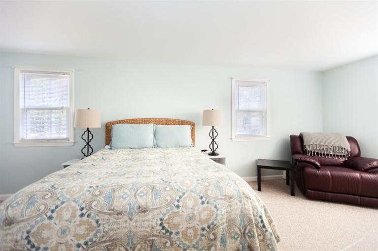 276 Bumps River Road Osterville, MA 02655 - Photo 14 of 29 a bedroom with a bed couch and window