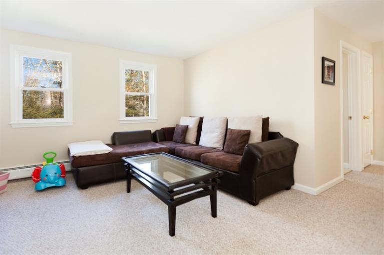 276 Bumps River Road Osterville, MA 02655 - Photo 17 of 29 a living room with furniture and a baby crib