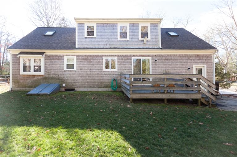 276 Bumps River Road Osterville, MA 02655 - Photo 24 of 29 a backyard of a house with table and chairs
