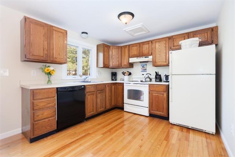276 Bumps River Road Osterville, MA 02655 - Photo 6 of 29 a kitchen with a sink a stove a refrigerator and cabinets