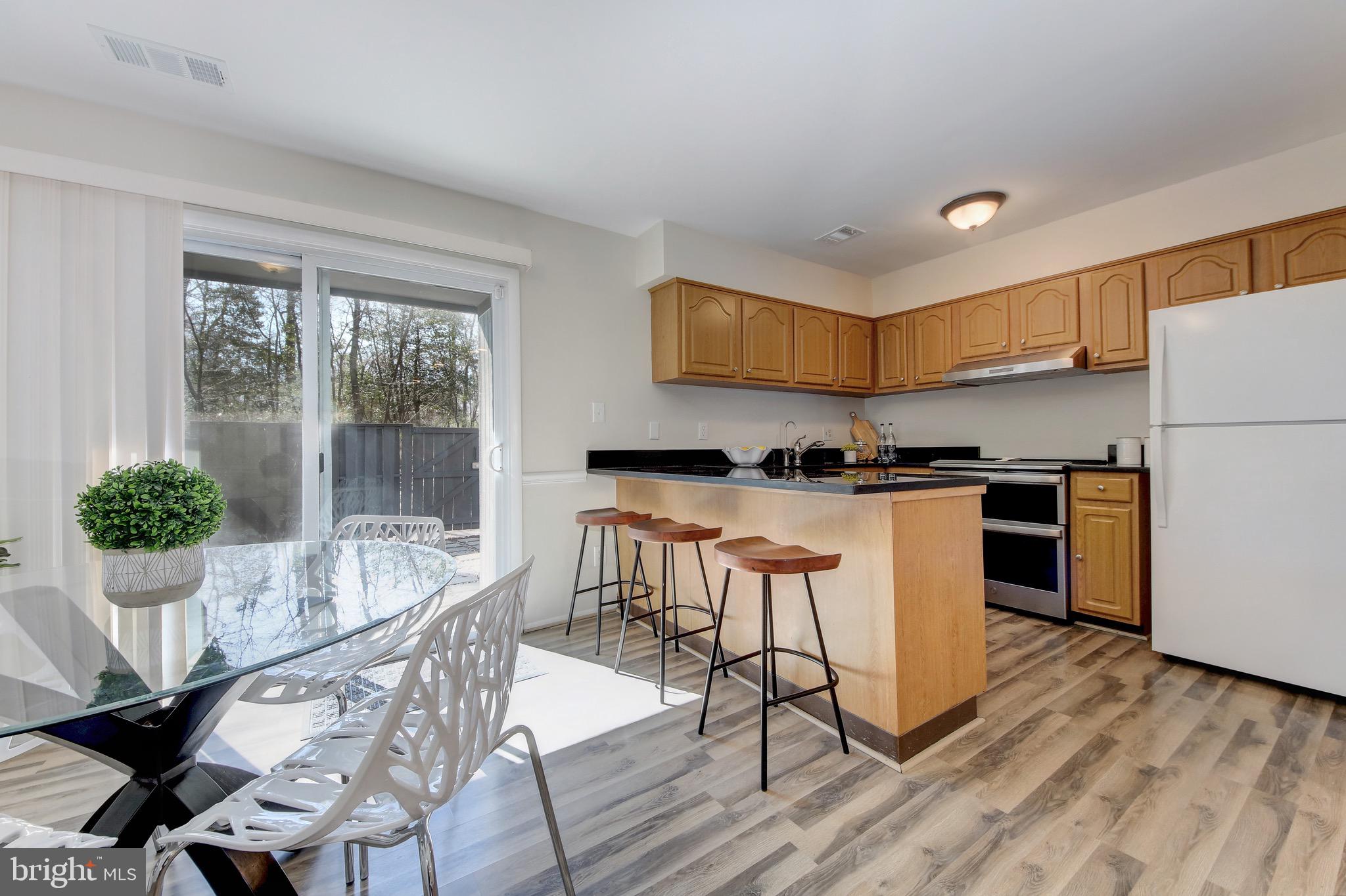2235 Cartwright Place Reston, VA 20191 - Photo 6 of 43 Dining room is open to kitchen w/ eat-in peninsula