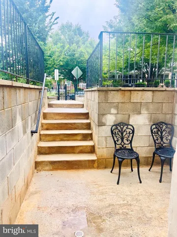 a view of two chairs in a patio with a yard