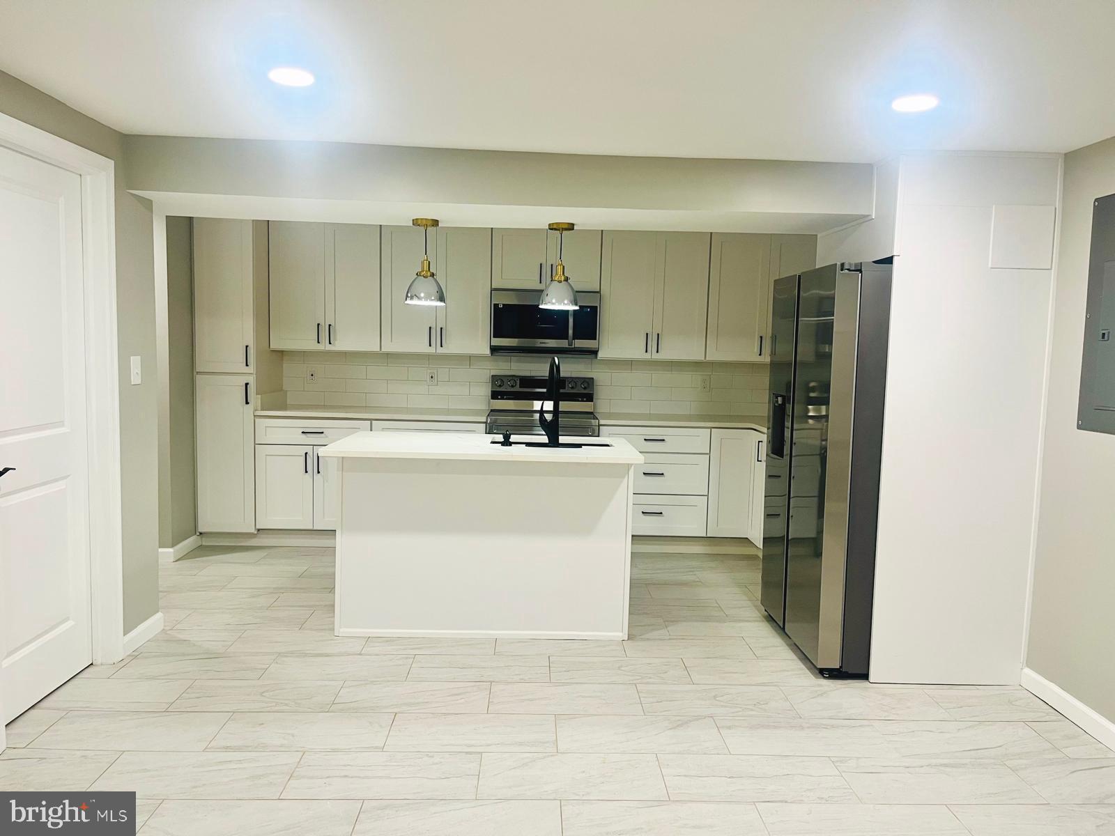 1319 C Street Northeast, Unit B Washington, DC 20002 - Photo 3 of 14 a kitchen with cabinets and a stove top oven