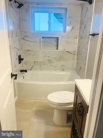 a bathroom with a sink a toilet and bathtub
