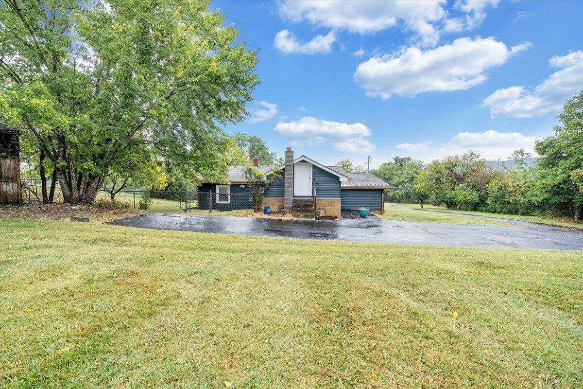 4515 Yellow Mountain Road Roanoke, VA 24014 - Photo 42 of 52 a house view with swimming pool and trees in the background
