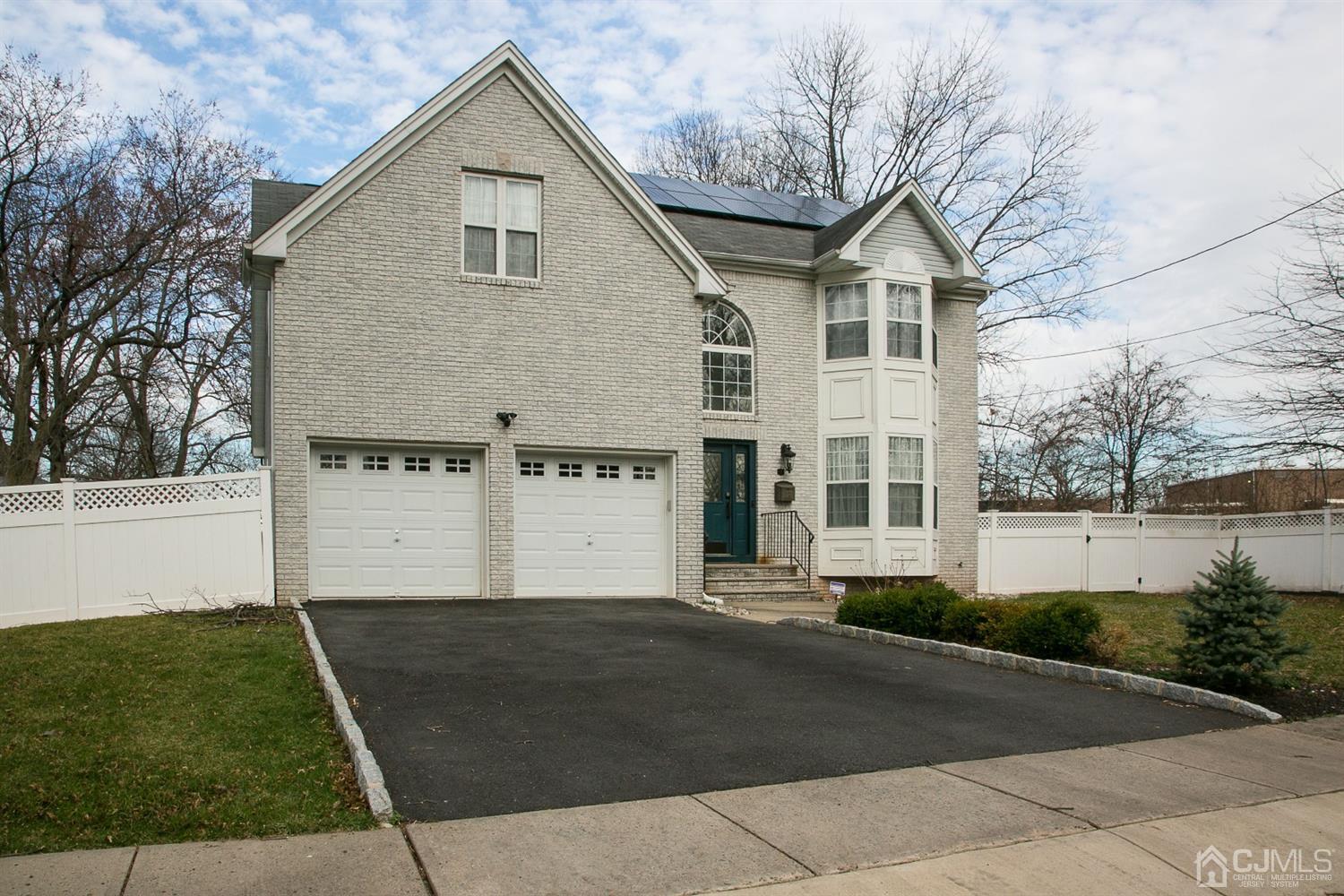 12 Lenox Street Edison, NJ 08817 - Photo 2 of 33 a front view of a house with a yard and garage