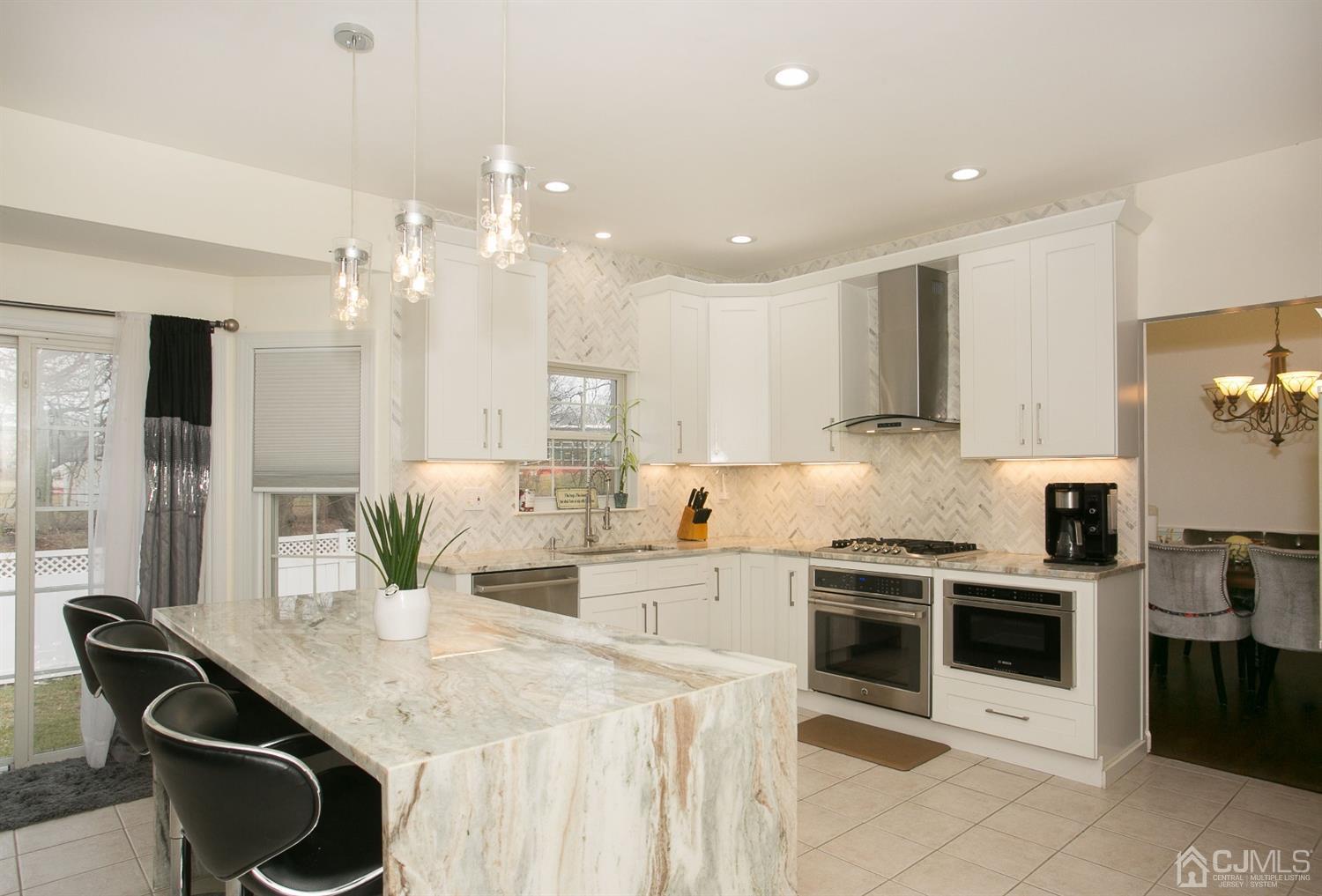 12 Lenox Street Edison, NJ 08817 - Photo 15 of 33 a kitchen with stainless steel appliances kitchen island granite countertop a sink and cabinets