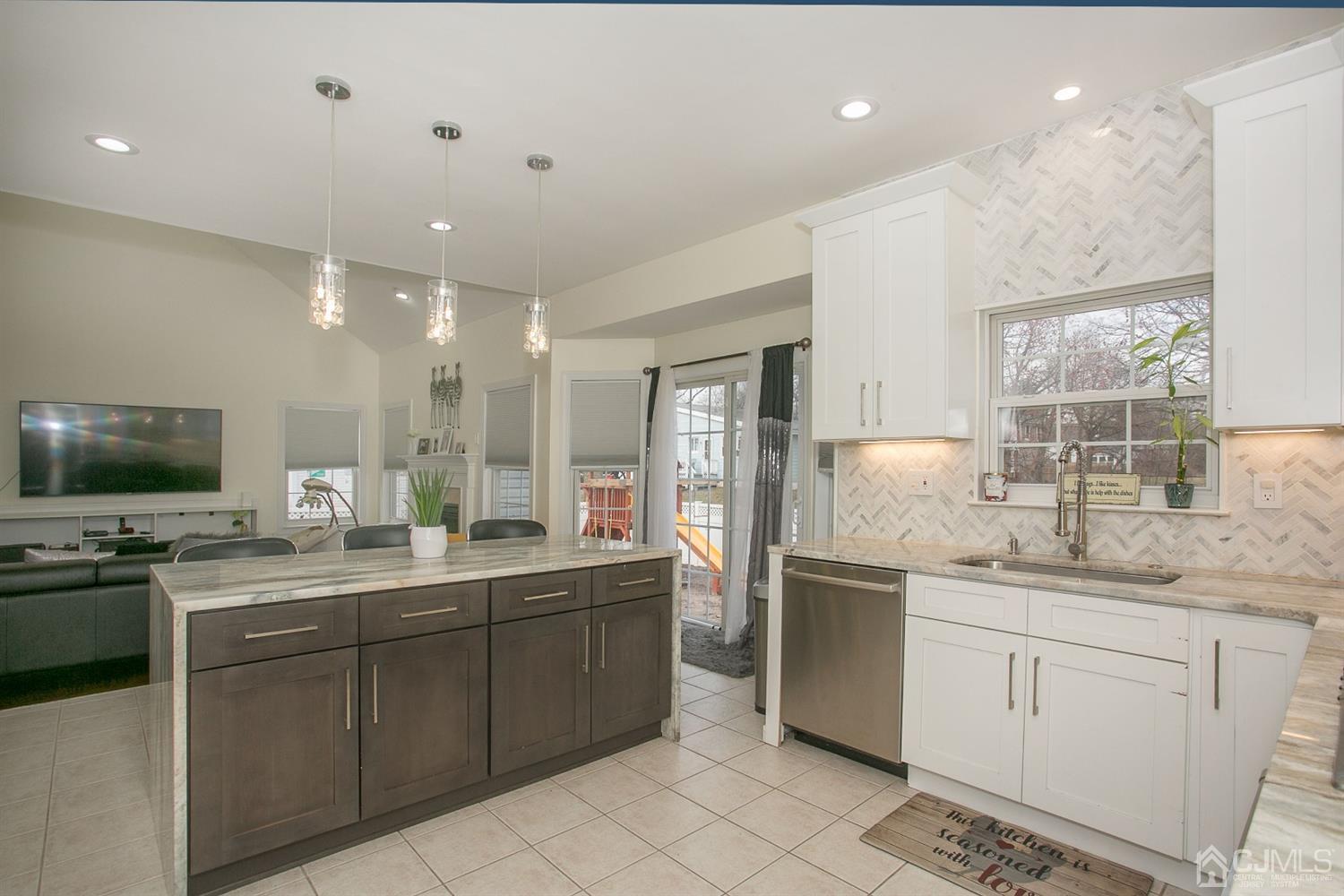 12 Lenox Street Edison, NJ 08817 - Photo 17 of 33 a kitchen with stainless steel appliances granite countertop a sink and stove top oven with wooden floor