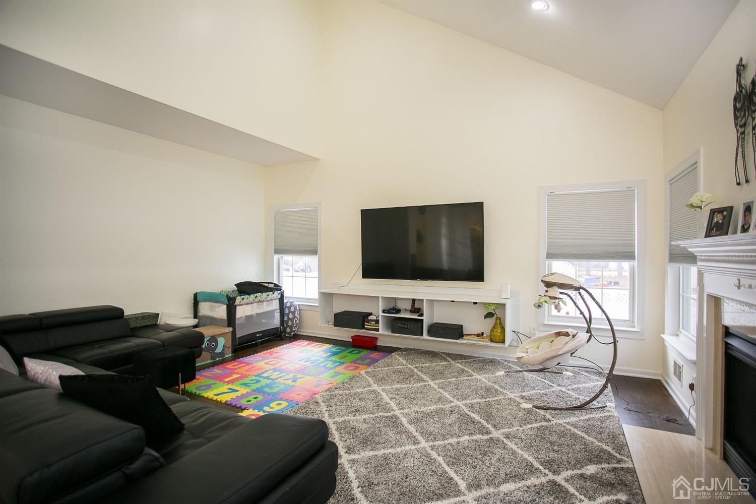 12 Lenox Street Edison, NJ 08817 - Photo 19 of 33 a living room with furniture and a flat screen tv
