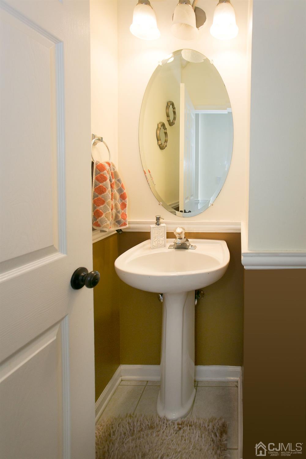 12 Lenox Street Edison, NJ 08817 - Photo 21 of 33 a bathroom with a sink and mirror