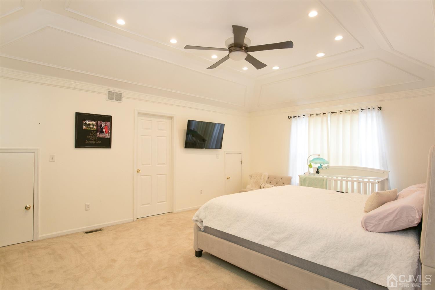 12 Lenox Street Edison, NJ 08817 - Photo 25 of 33 a bedroom with a bed and a flat screen tv