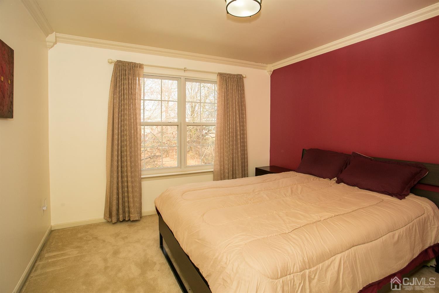 12 Lenox Street Edison, NJ 08817 - Photo 30 of 33 a large bed sitting in a bedroom next to a window