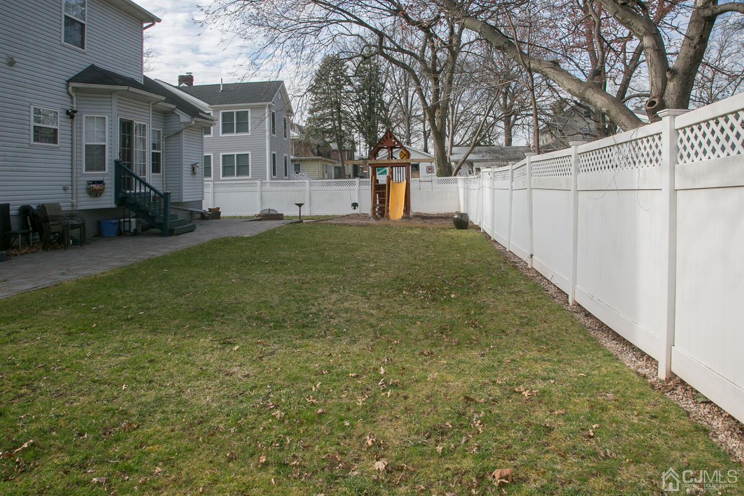 12 Lenox Street Edison, NJ 08817 - Photo 4 of 33 a view of a backyard with a white fence
