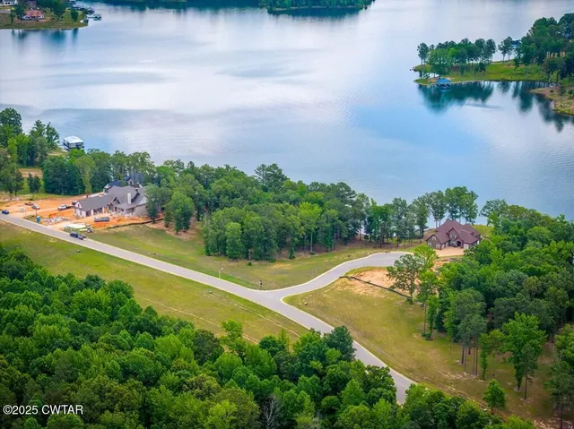 an aerial view of a house with a lake view