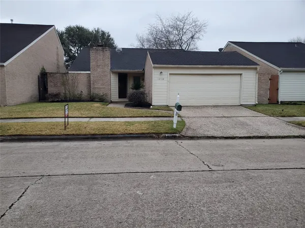 a front view of a house with a yard and a garage
