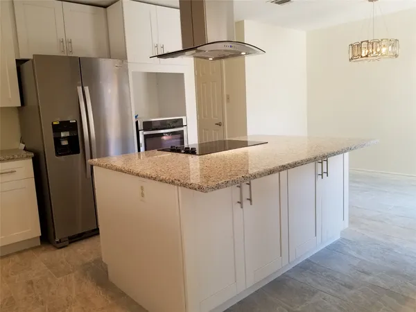 a kitchen with stainless steel appliances a refrigerator and a stove