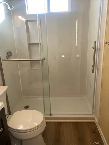 a bathroom with a toilet and a shower