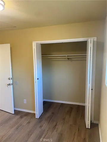 an empty room with wooden floor