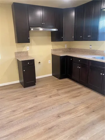 a kitchen with wooden cabinets