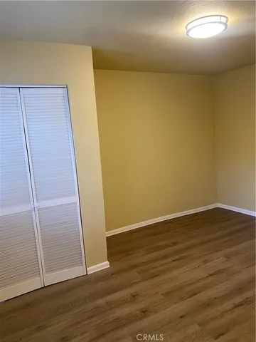 an empty room with wooden floor