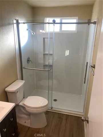 a bathroom with a toilet and a shower